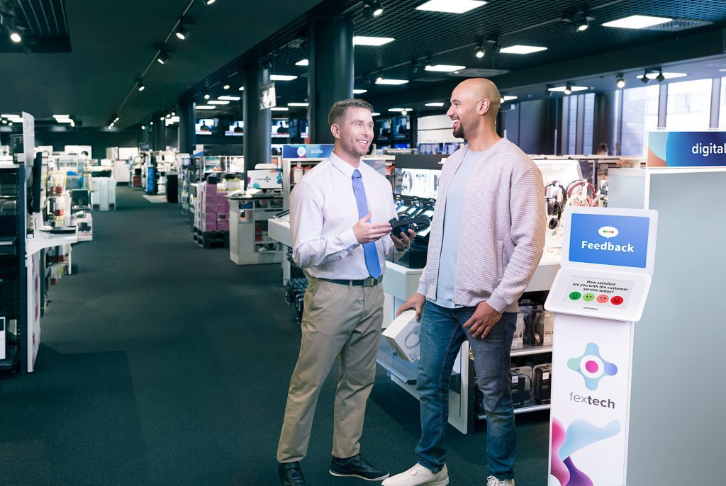 Retail environment with HappyOrNot Kiosk collecting customer feedback in store